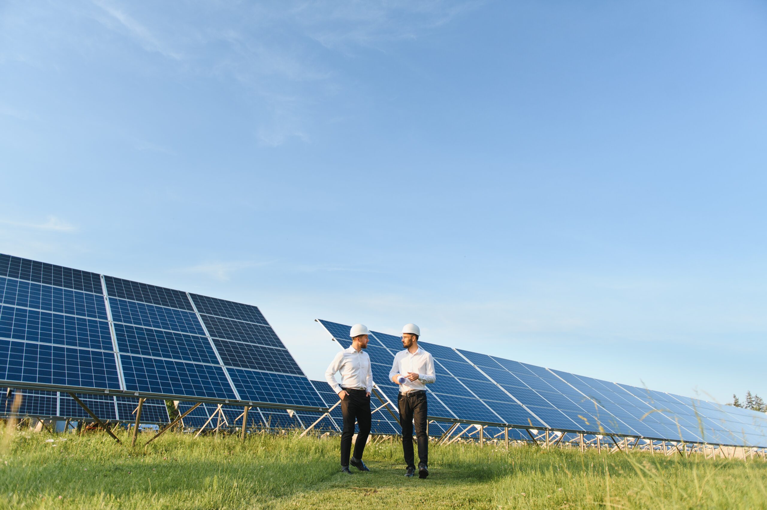 The solar farm(solar panel) with two engineers walk to check the operation of the system, Alternative energy to conserve the world's energy, Photovoltaic module idea for clean energy production